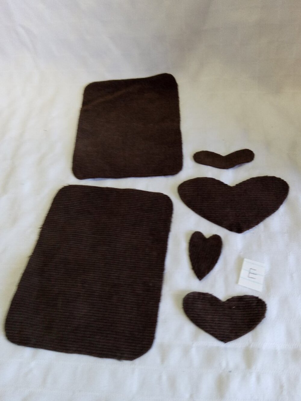 Two handmade elbow patches for sewing made of brown corduroy with hearts